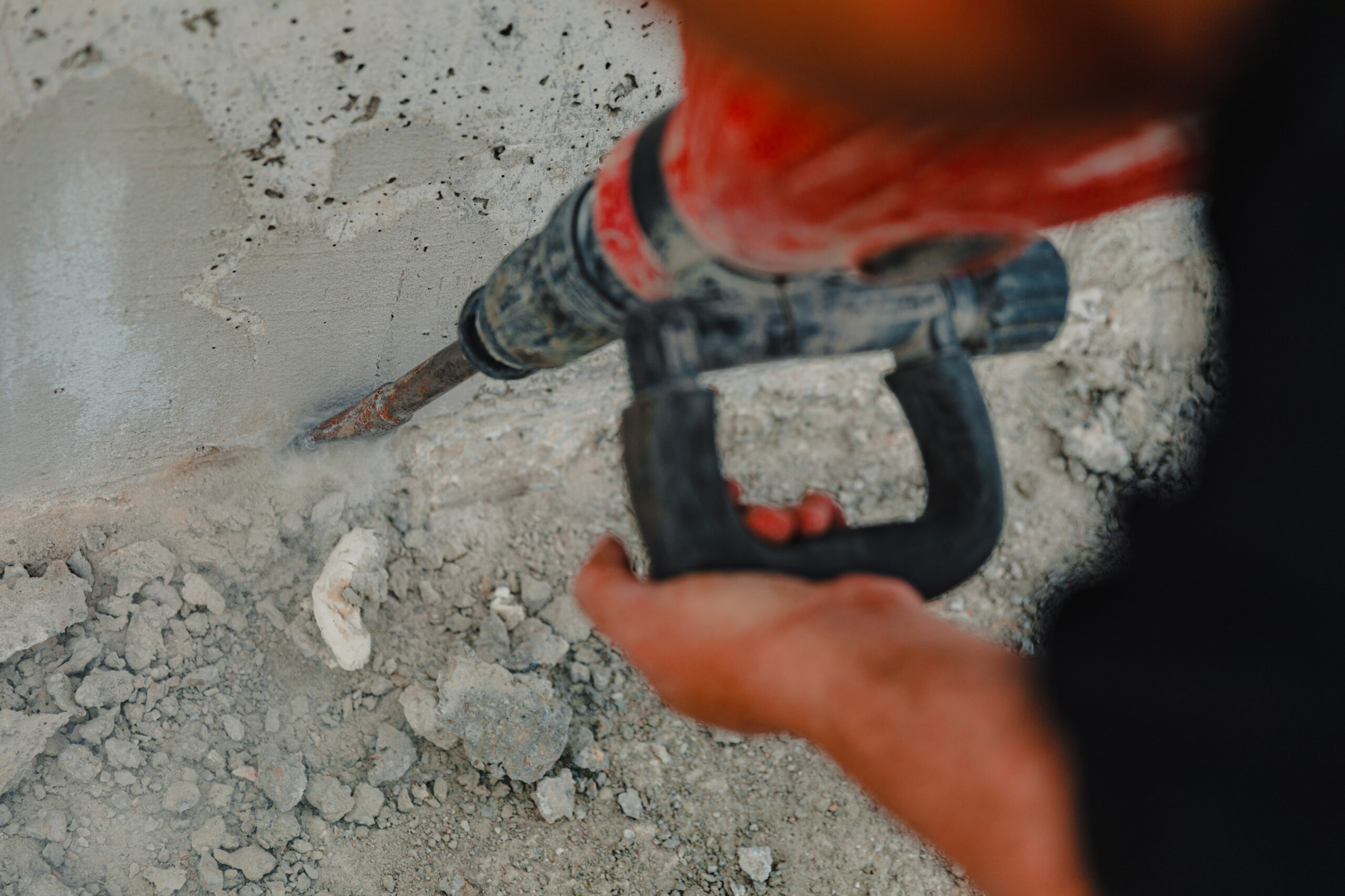 construction worker using a jackhammer on concrete