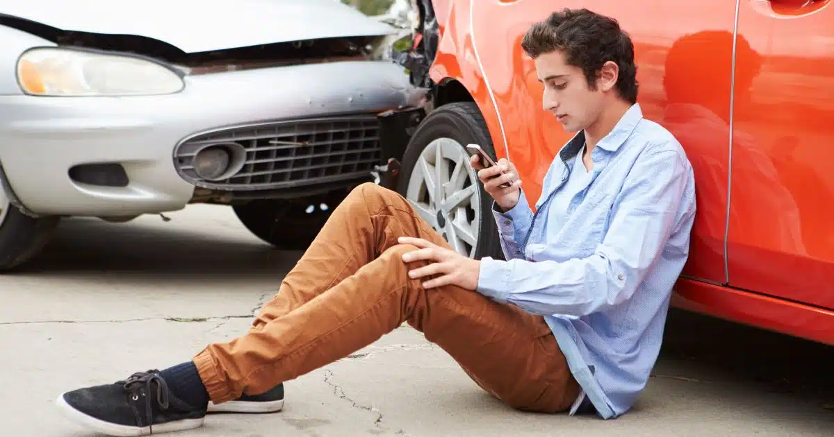 employee using phone to contact work after a car accident