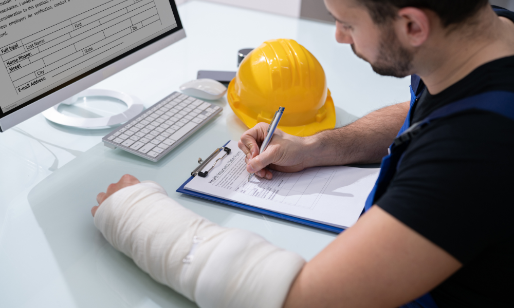 injured construction worker filling out paperwork